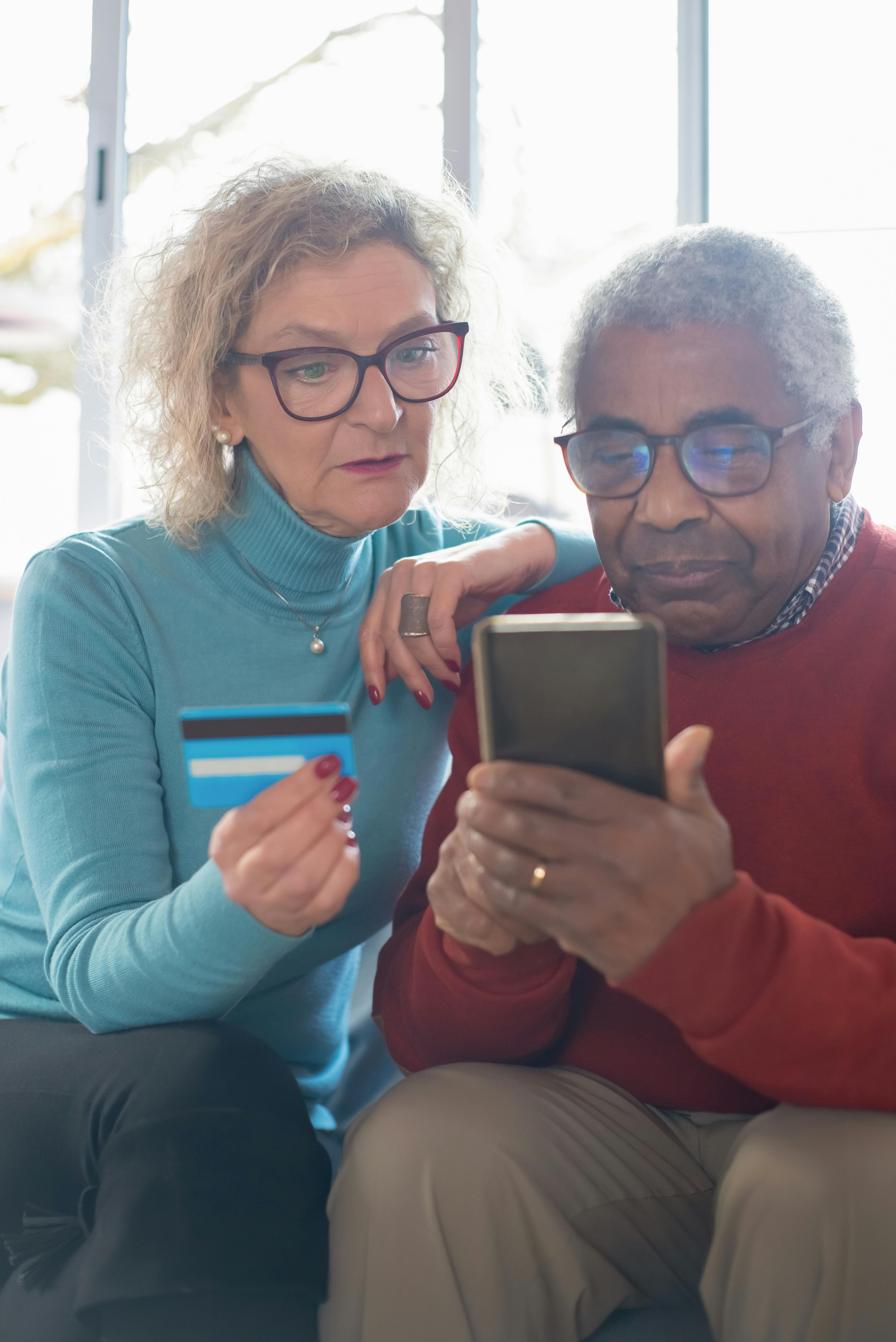 Happy couple reviewing Medicare options with an agent